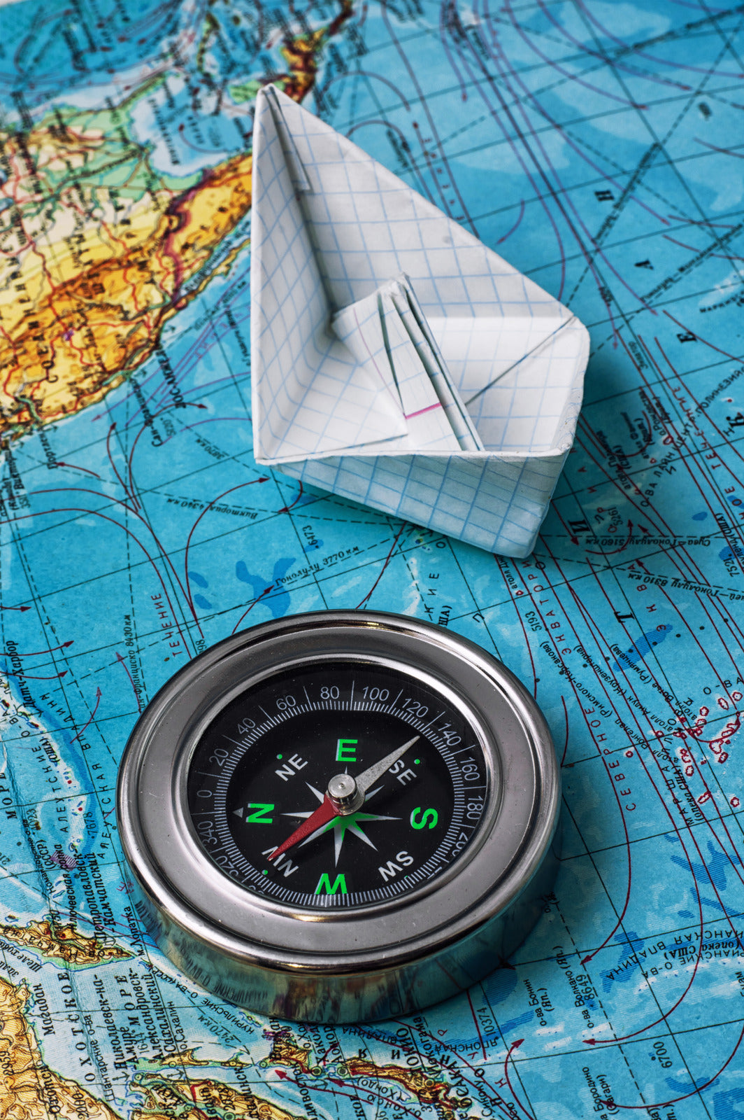 Compass & Paper Boat on a Map
